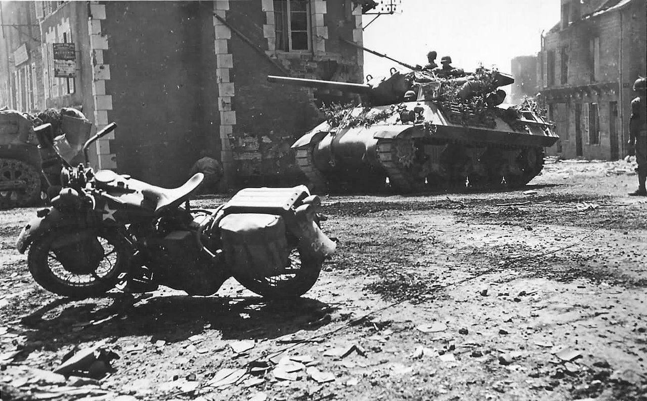 Camouflaged_M10_Tank_Destroyer_And_Harley_Davidson_In_Percy_France_08_1944.jpg