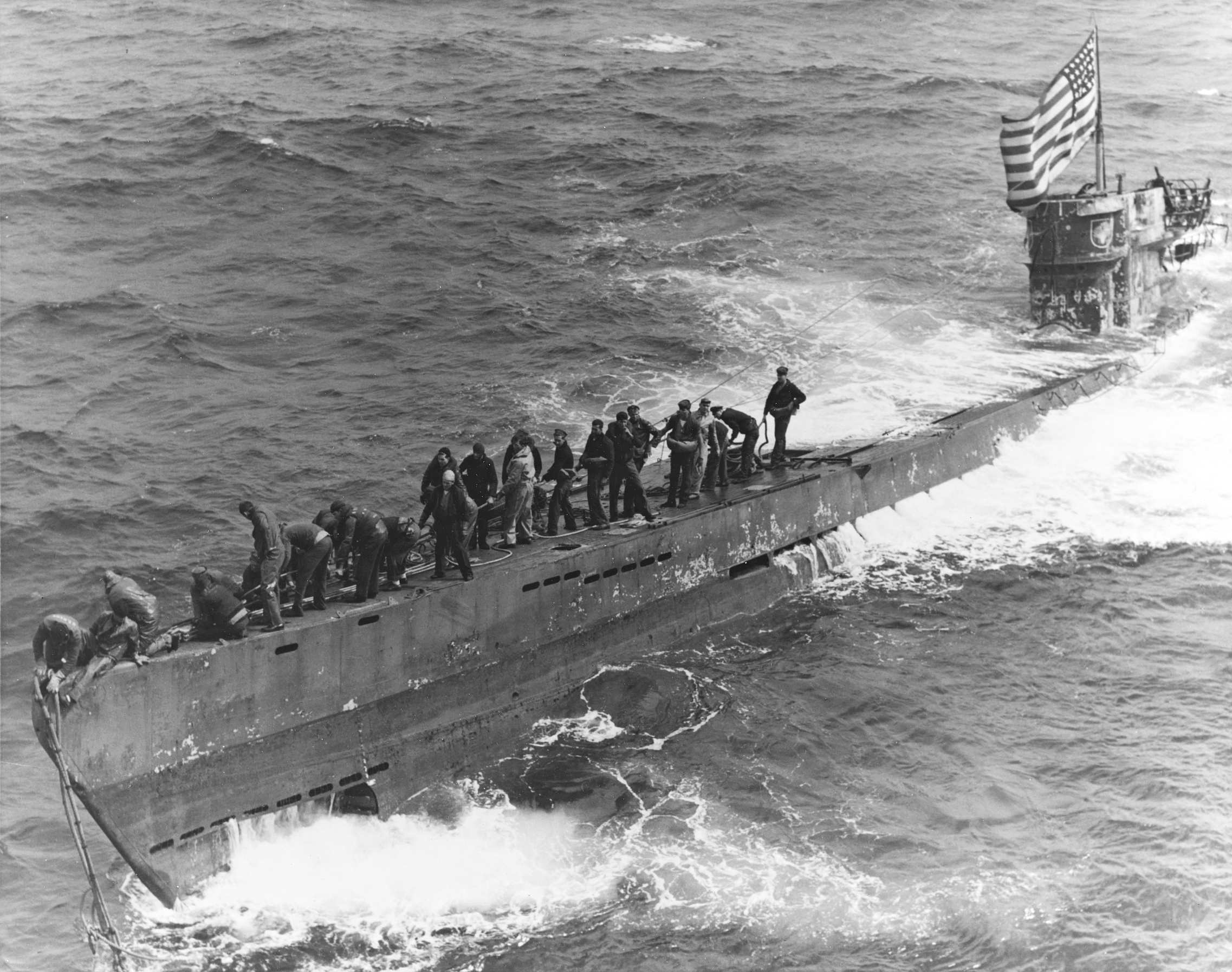 A_U.S._Navy_boarding_party_working_to_secure_a_tow_line_to_the_bow_of_the_captured_German_subm...jpg