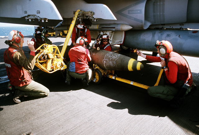 an-ordnance-crew-member-uses-an-hlu-196-bomb-hoist-to-mount-a-mark-84-2000-183009.jpg