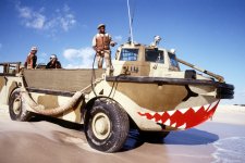 Decorated with menacing teeth, a LARC-5 amphibious cargo carrier crosses a beach on the Persia...jpg