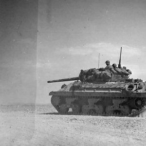 M10_Tank_Destroyer_Heads_To_Battle_Lines_At_Bir_Marbott_Pass_East_Of_El_Guettar_In_Tunisia_1943.jpg