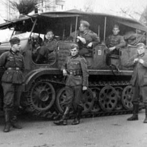 Wehrmacht_soldiers_next_to_a_SdKfz_6_halftrack.jpg