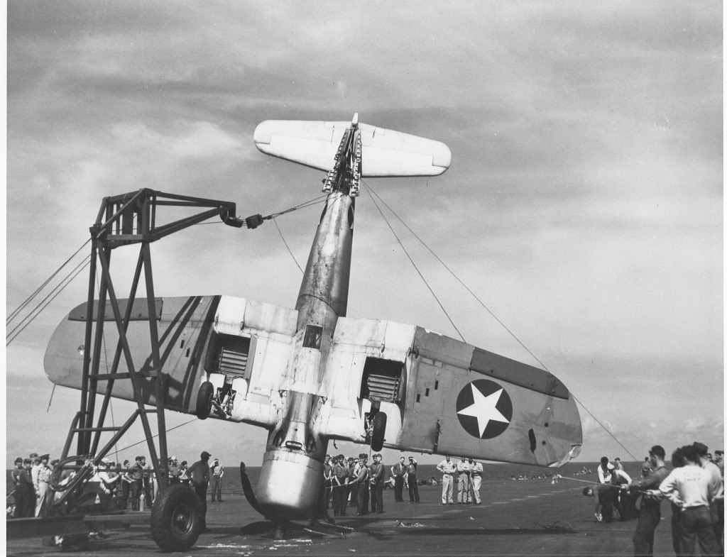 F4U-1CorsairaircraftofVF-17isbeingliftedfromthedeckofUSSBunkerHillCV-17_zps1938c7a8.jpg