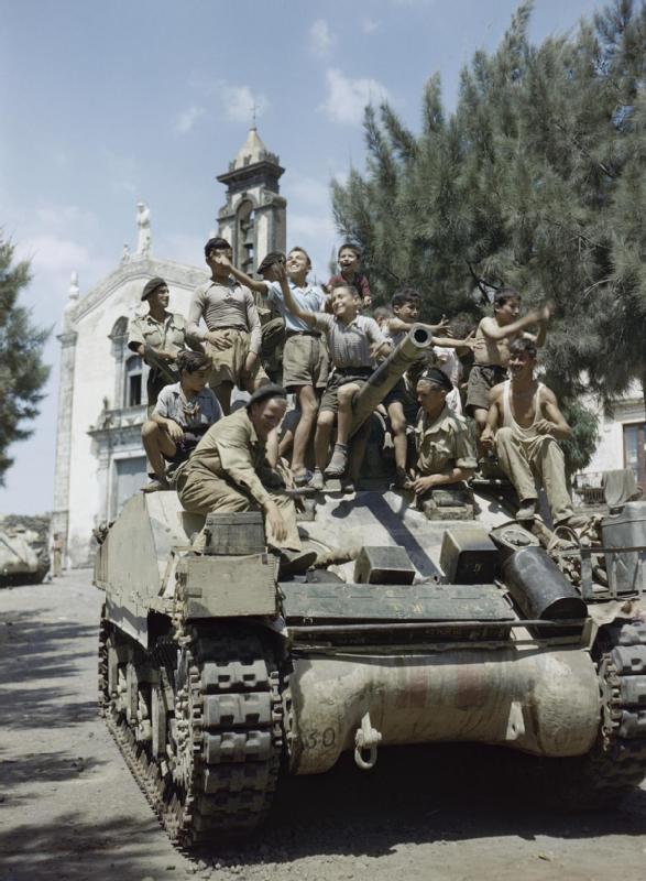 Local_children_crowd_aboard_a_Sherman_Mk_III_tank_of_the_County_of_London_Yeomanry_in_the_village_of_Milo_near_Catania_in_Sicily2C_August_1943__TR1244