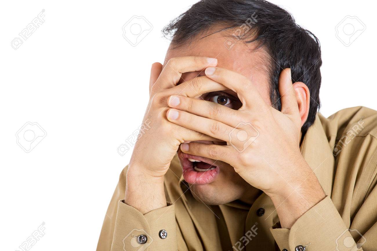 25792534-Closeup-portrait-of-scared-shy-business-man-covering-face-nose-mouth-with-hands-fingers-peering-thro-Stock-Photo.jpg