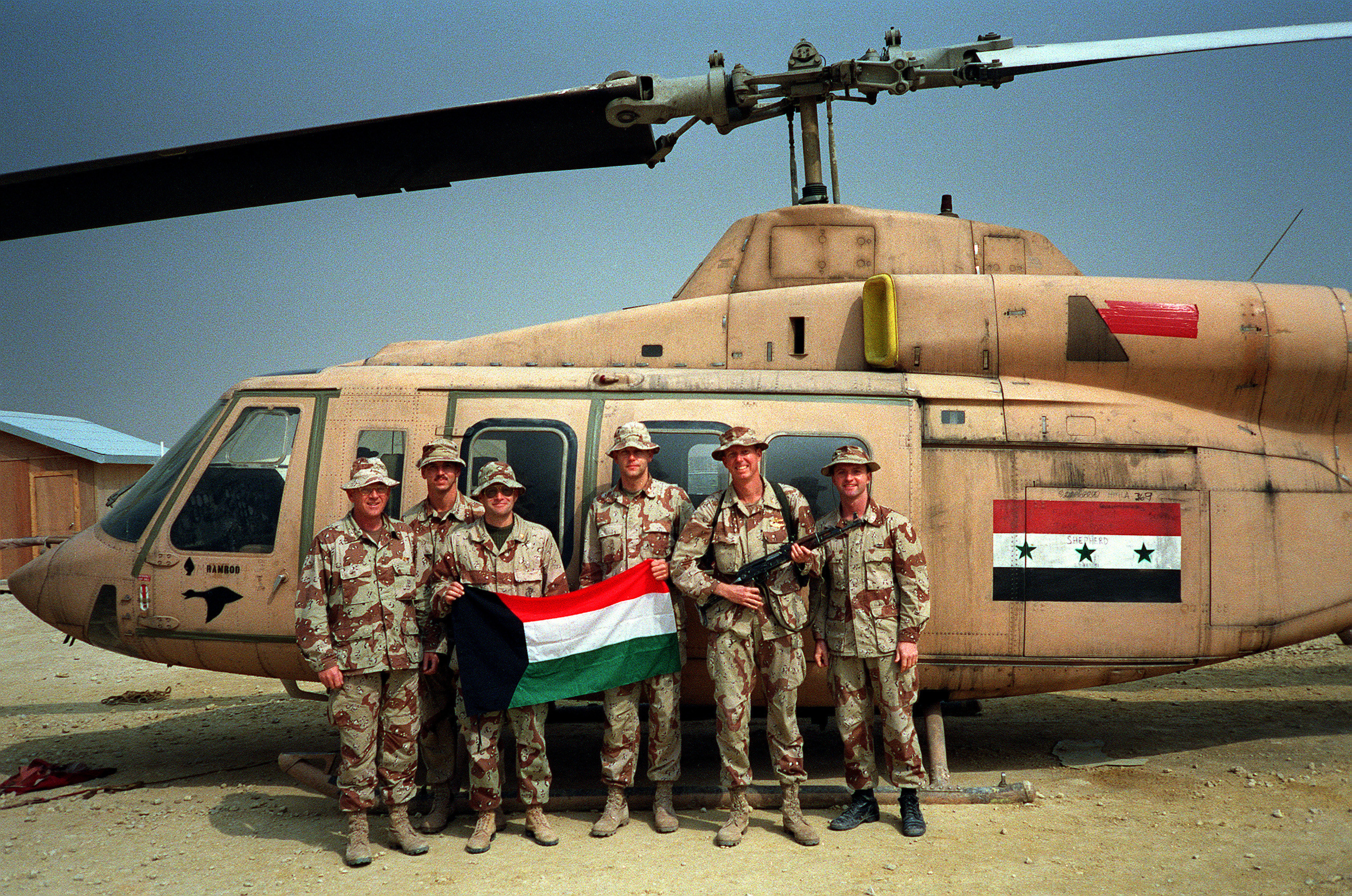 Members_of_the_staff_of_the_3rd_Marine_Aircraft_Wing_stand_in_front_of_a_captured_Iraqi_Bell_214ST_Transport_helicopter_during_Operation_Desert_Storm.JPEG